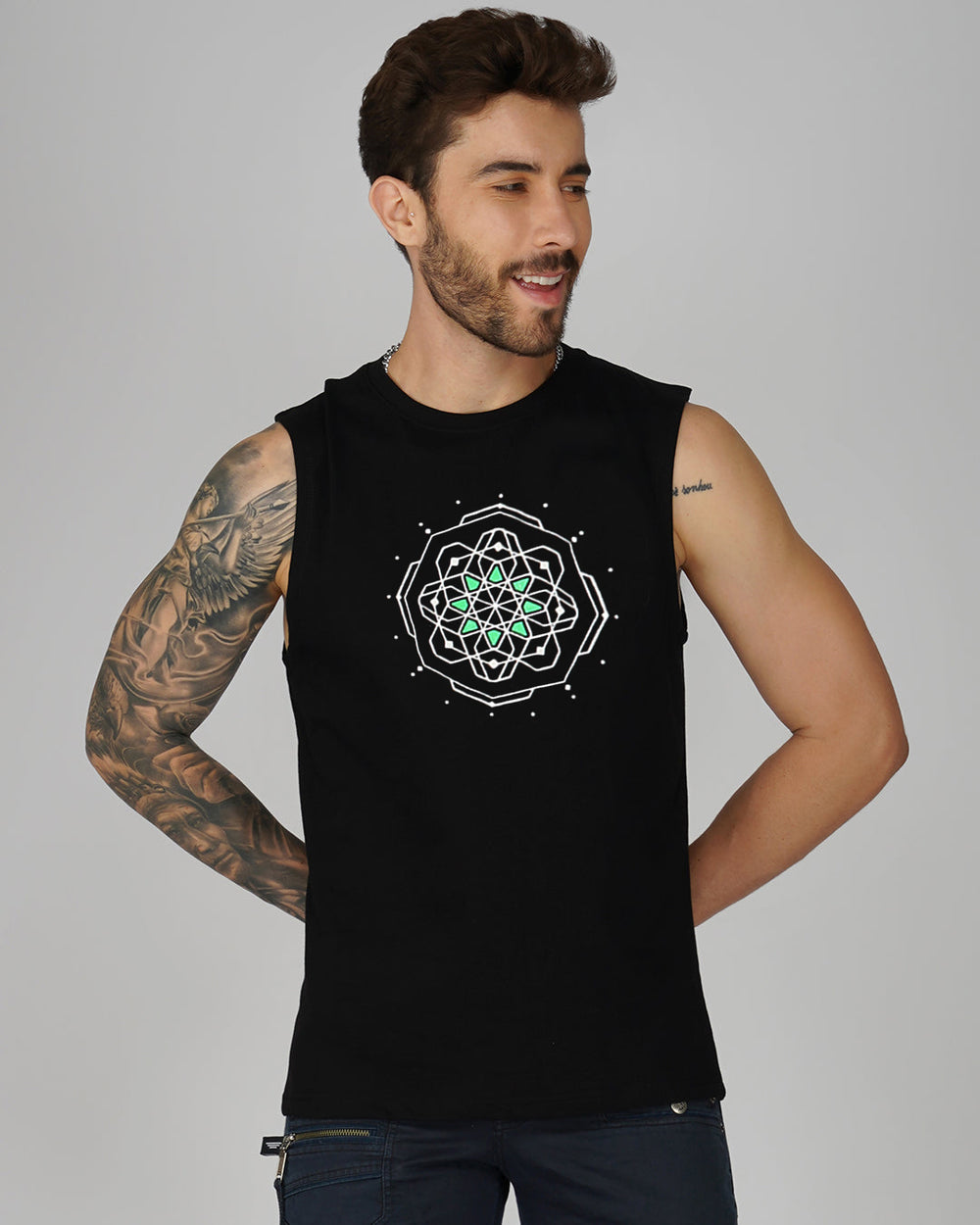 Man wearing a black sleeveless shirt with a geometric design on a gray background