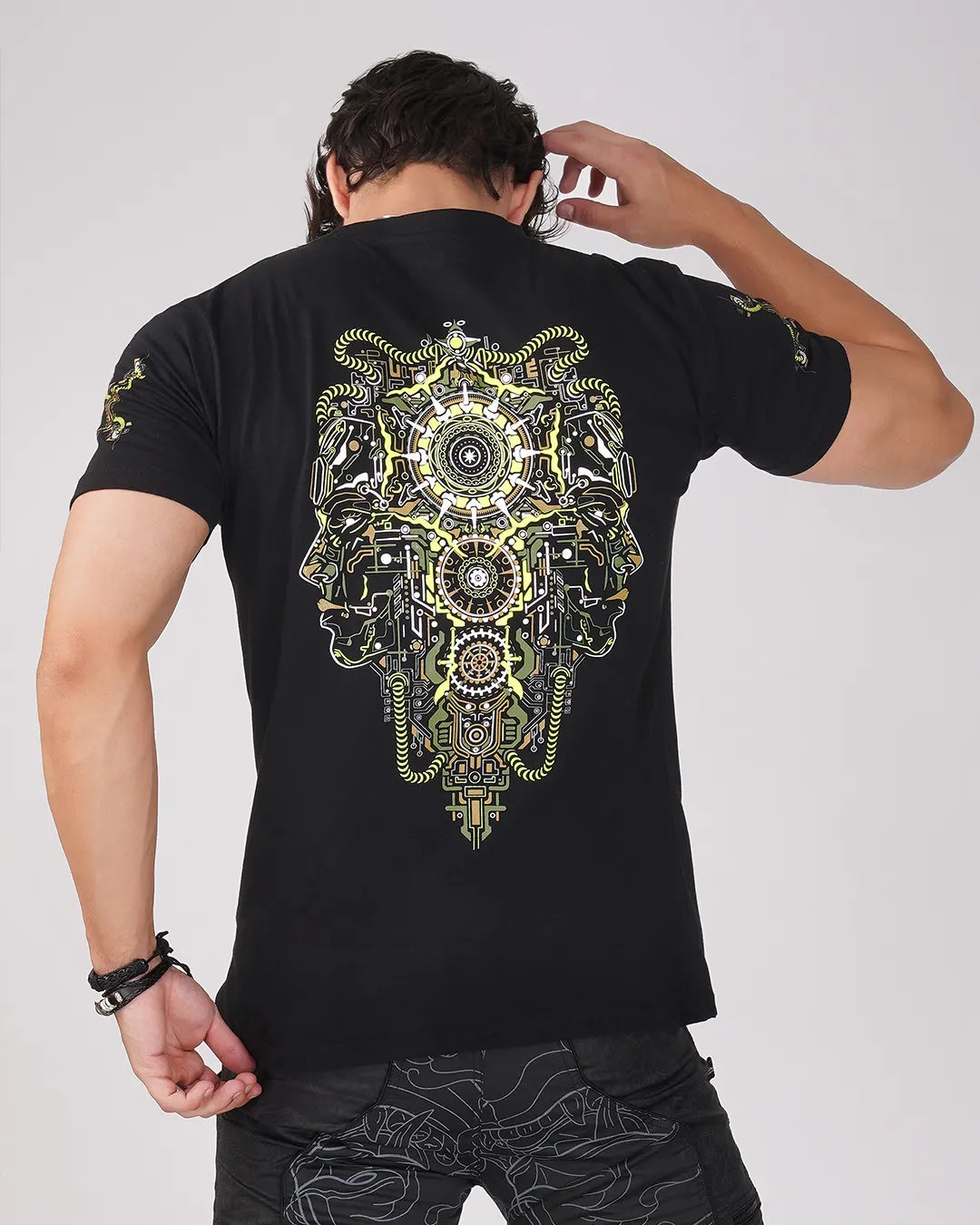 Person wearing a black t-shirt with a detailed design on the back against a plain background