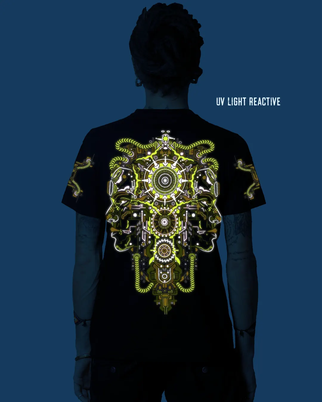 Person wearing a black t-shirt with a UV light reactive design on the back against a blue background.
