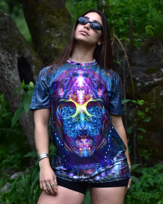 Person wearing a colorful graphic t-shirt with a vibrant design outdoors.