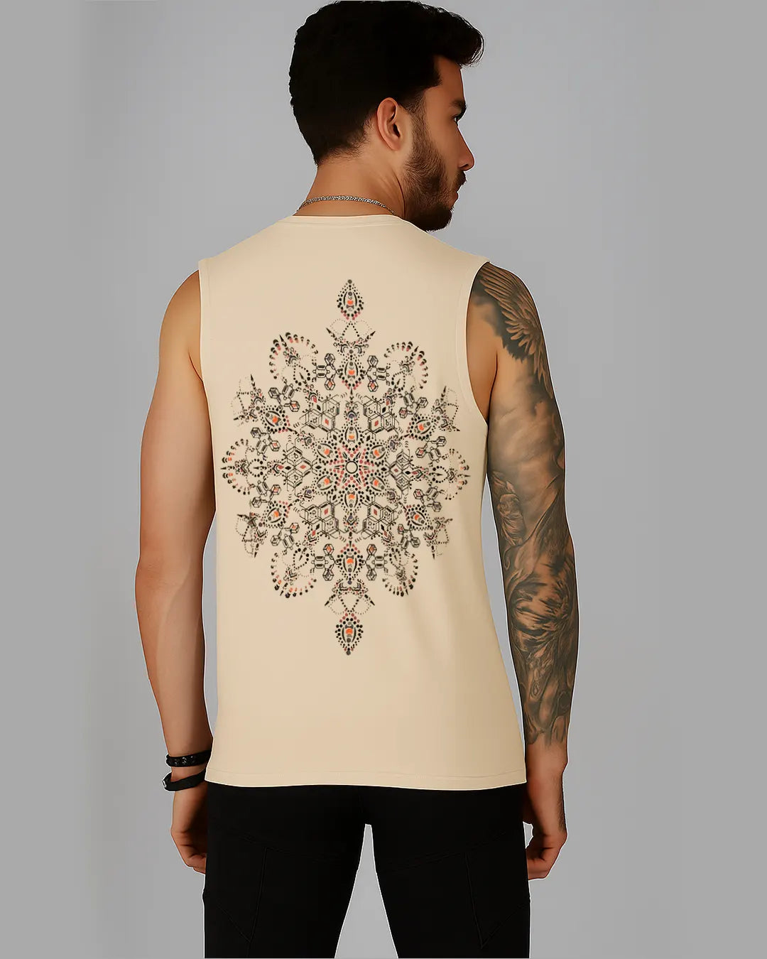 Man wearing a beige sleeveless shirt with a decorative back design on a gray background