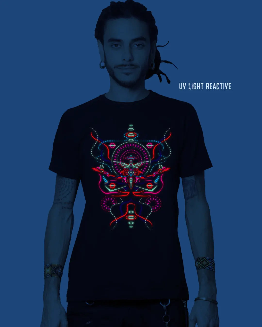 Person wearing a black t-shirt with a colorful UV light reactive design on a dark background