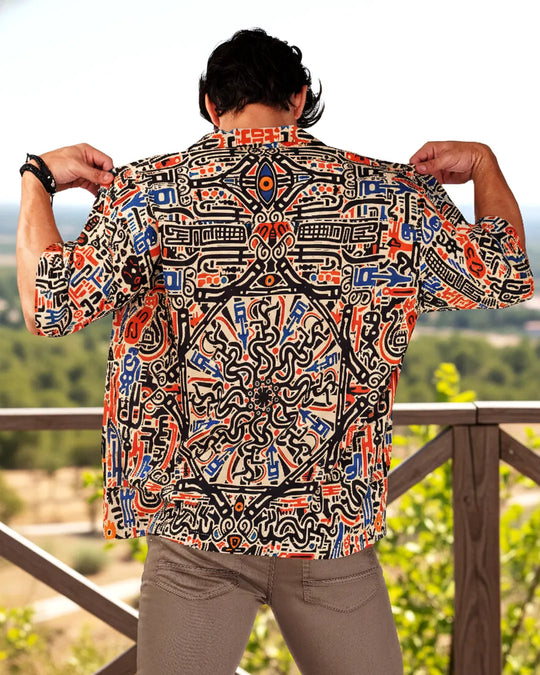Person wearing a colorful patterned shirt with a scenic background
