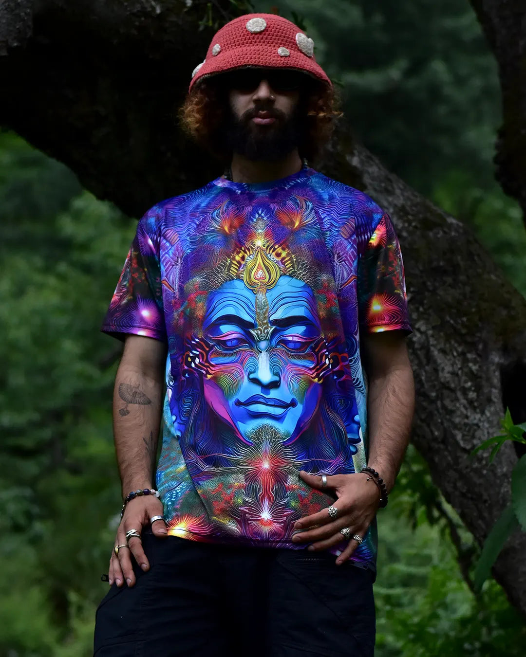 Person wearing a colorful t-shirt with a face design in a natural setting