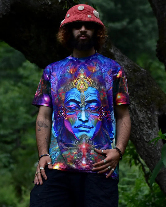 Person wearing a colorful t-shirt with a face design in a natural setting
