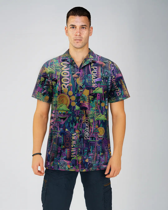 Man wearing a colorful patterned shirt on a plain background