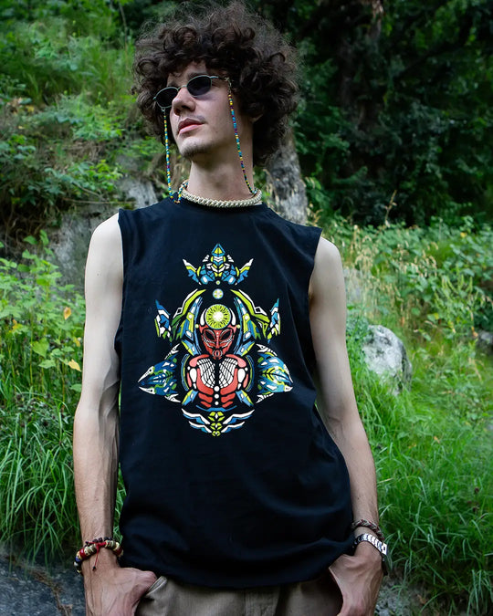 Person wearing a black sleeveless shirt with a colorful graphic design outdoors.