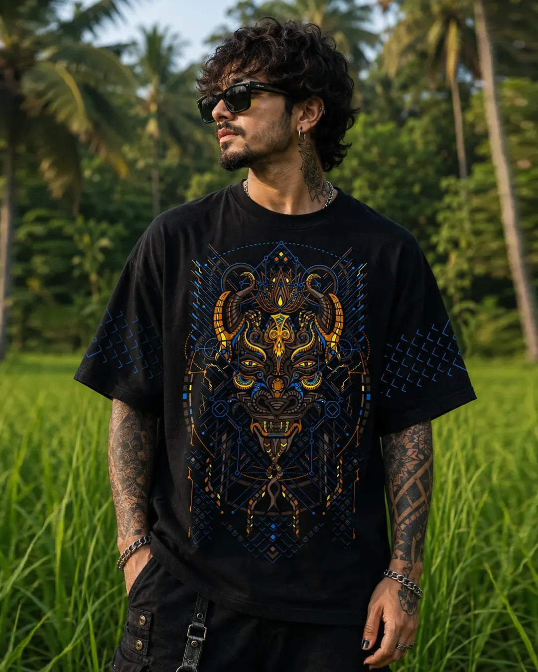 Black Kanina oversized T-shirt featuring intricate blue and orange mask artwork, geometric sleeve prints and a matching back design by Ultra Tribe.