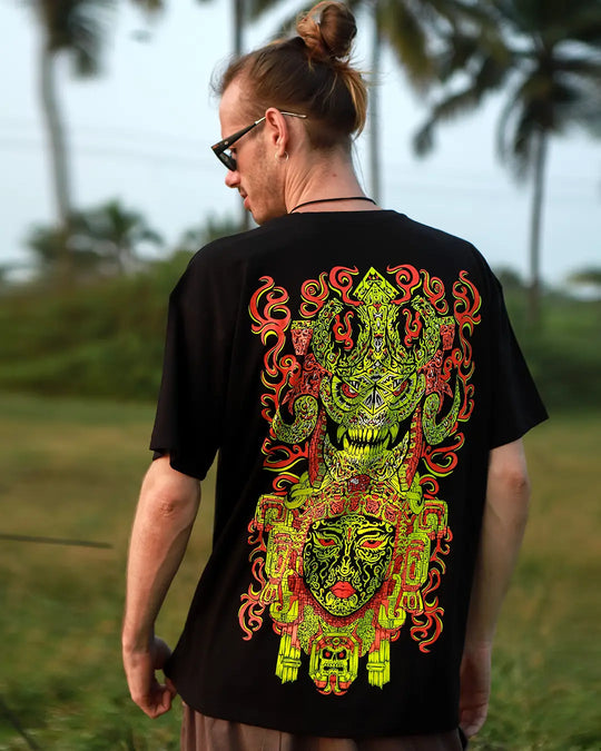 Person wearing a black t-shirt with a colorful graphic design outdoors