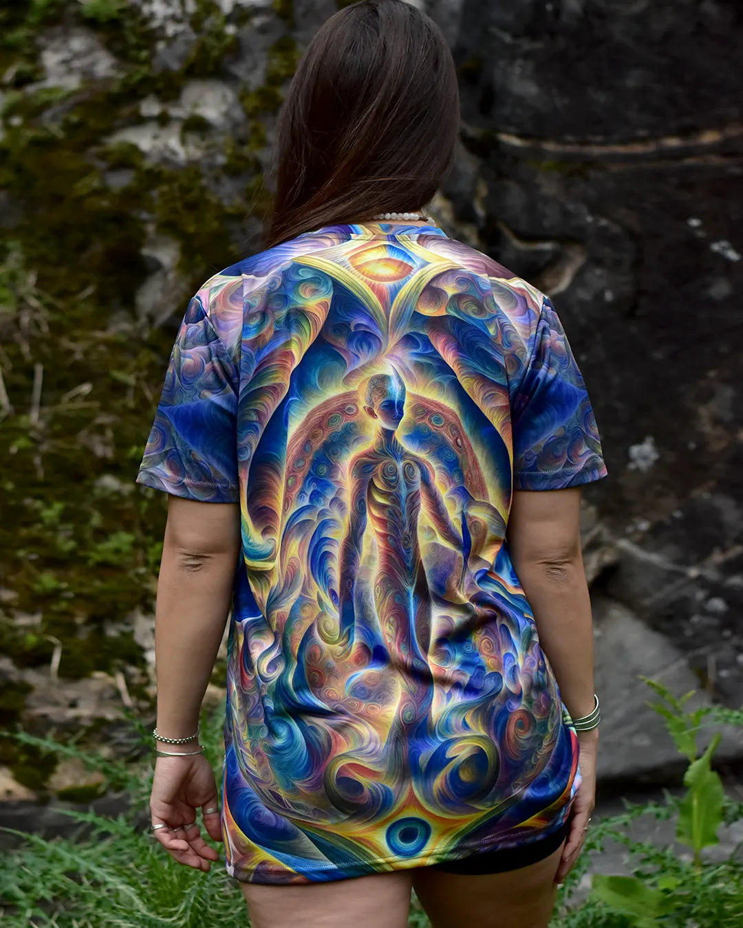 Person wearing a colorful t-shirt with abstract design outdoors
