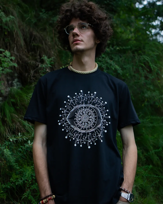 Person wearing a black t-shirt with a white graphic design outdoors