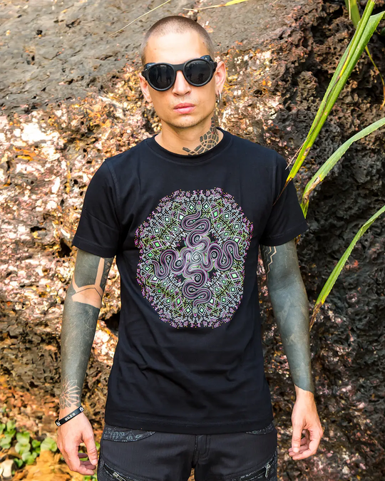 Person wearing a black t-shirt with a colorful octopus design outdoors.