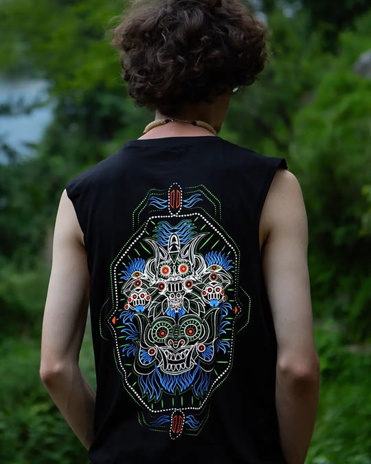 Person wearing a black sleeveless shirt with a colorful dragon design on the back, standing outdoors.