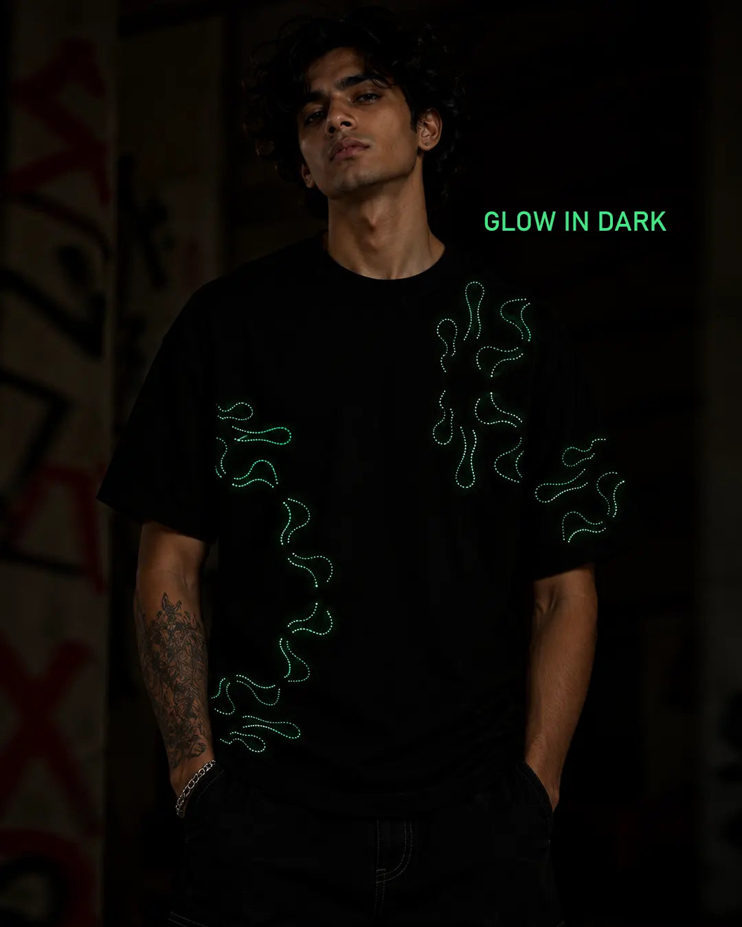 Stellar Oasis glow-in-the-dark T-shirt displaying its luminous artwork in dark conditions.
