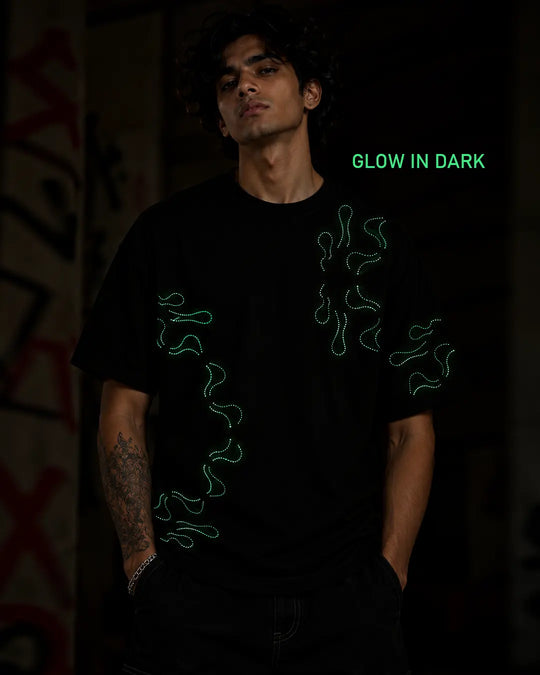 Stellar Oasis glow-in-the-dark T-shirt displaying its luminous artwork in dark conditions.